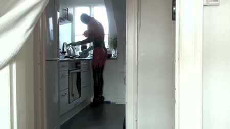 Latexskin Doing The Dishes - Latexskin doing the dishes wearing red and black latexsuit with boobs, stilettos and mask